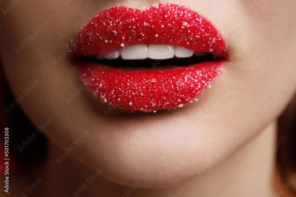 Closeup view of woman with lips covered in sugar Closeup view of woman with lips covered in sugar