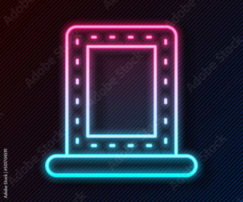 Glowing neon line Makeup mirror with lights icon isolated on black background. Vector