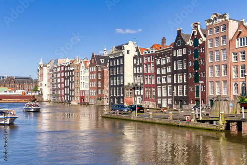 Amsterdam/Holland - May 15th 2013: Amsterdam canal and famous Dutch style tall buildings