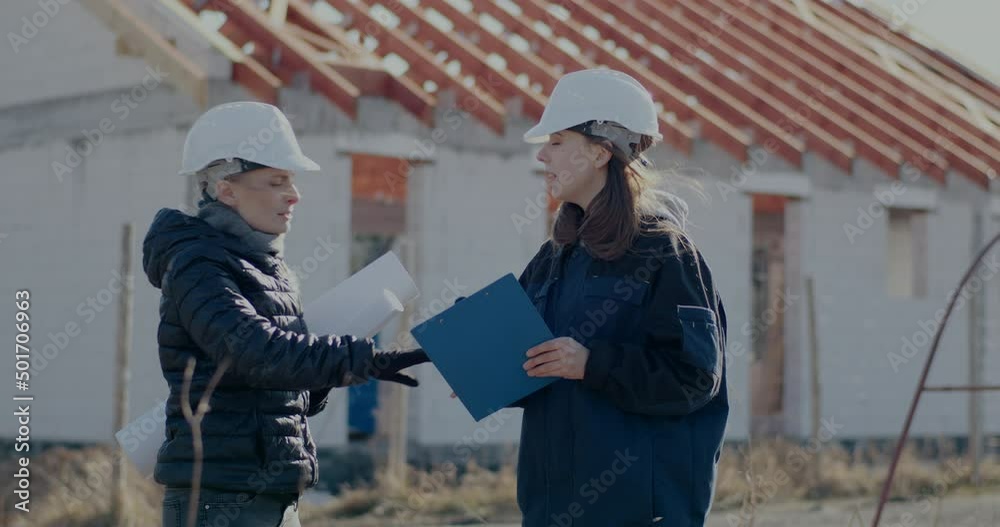 Female contractor arguing with engineer at incomplete site Female contractor arguing with engineer at incomplete site