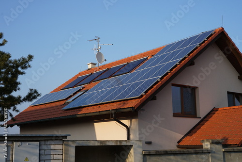 Modern house of future with efficient solar panels on roof, green renewable energy concept