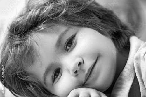 Close-up portrait of adorable happy little boy smiling at camera.