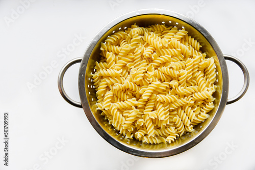 Boiled vermicelli noodles horns in a colander