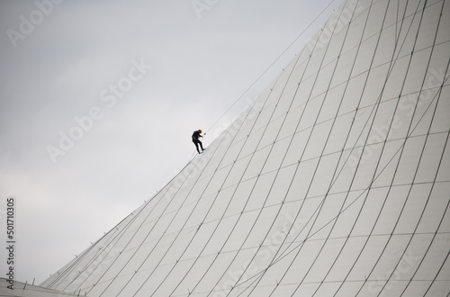 Person climbs to the top of a building