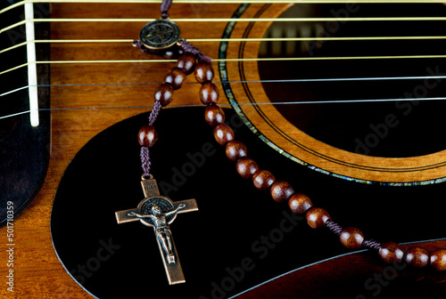 Canvas Print Crucifix and Rosary Beads on a Mahogany Acoustic Guitar