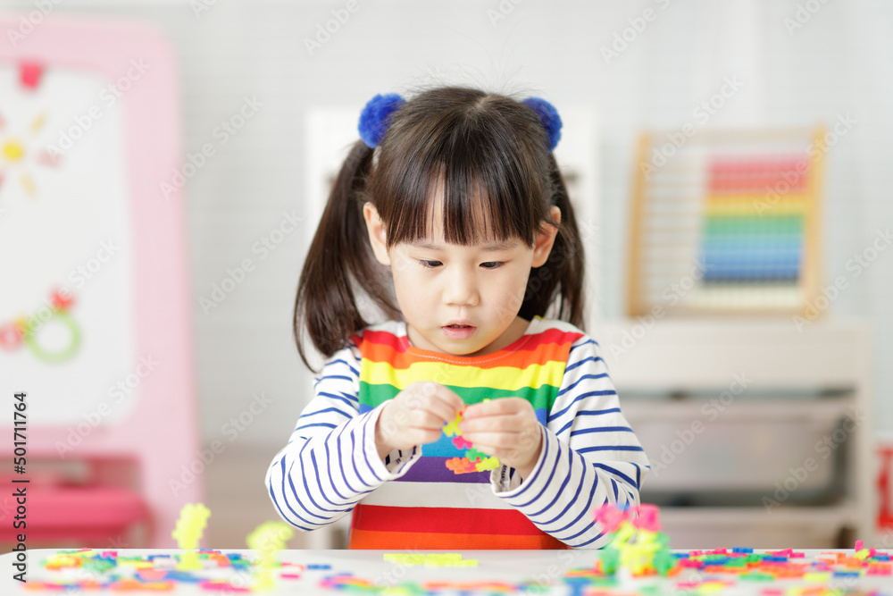 Fototapeta premium young girl playing creative blocks for homeschooling