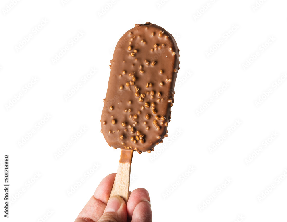 A woman holds an ice cream with chocolate and nuts by the stick. A cold chocolate popsicle is held by a woman's hand. Isolated A woman holds an ice cream with chocolate and nuts by the stick. A cold chocolate popsicle is held by a woman's hand. Isolated