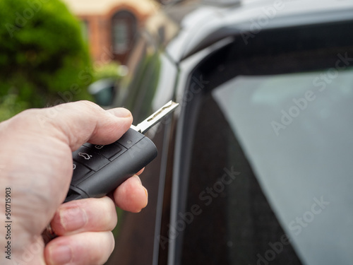 man with battery operated auto vehicle remote opening the doors and door mirrors