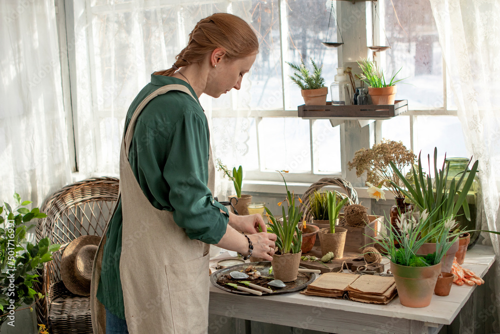 girl plants flowers in pots in spring girl plants flowers in pots in spring