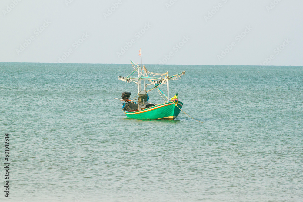 small fishing boat that catches fish and squid along the coast in a traditional way and maintains an ecosystem of fish and marine life for a long time on strong and windy days.