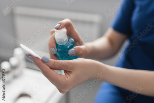 the cosmetologist applies the drug through a sprayer on a cotton pad