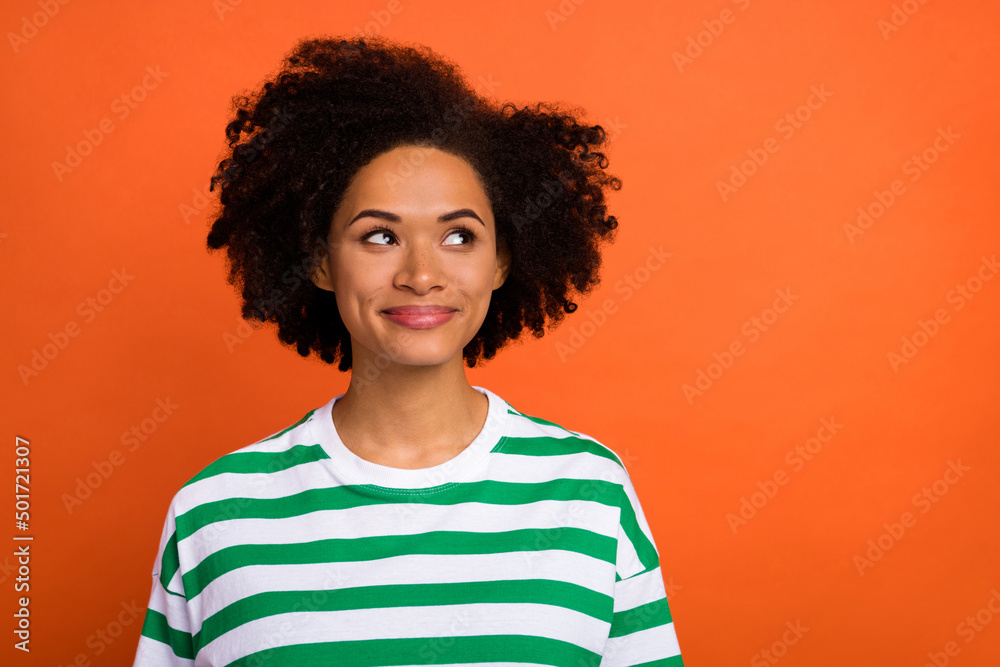 Portrait of attractive minded cheery smart girl overthinking copy blank space isolated over bright orange color background