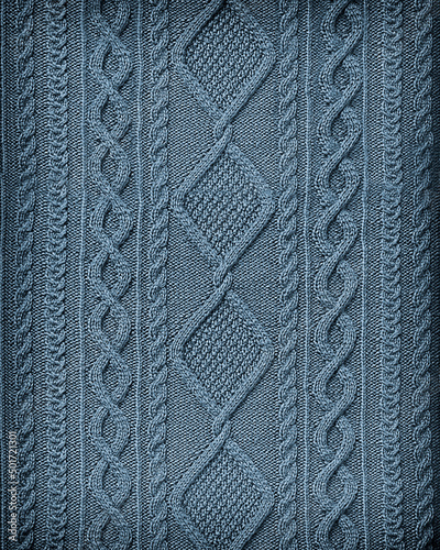 blue background texture patterned knitted fabric closeup. Embossed knitted arana pattern