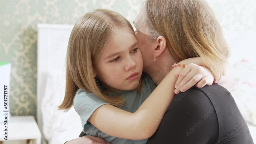 mom hugs and soothes her sad daughter. childish whims and tears. psychological trauma and fears. the relationship between parents and child. mom hugs and soothes her sad daughter. childish whims and tears. psychological trauma and fears. the relationship between parents and child.