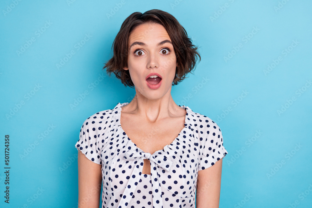 Portrait of impressed pretty person open mouth look camera news information isolated on blue color background Portrait of impressed pretty person open mouth look camera news information isolated on blue color background