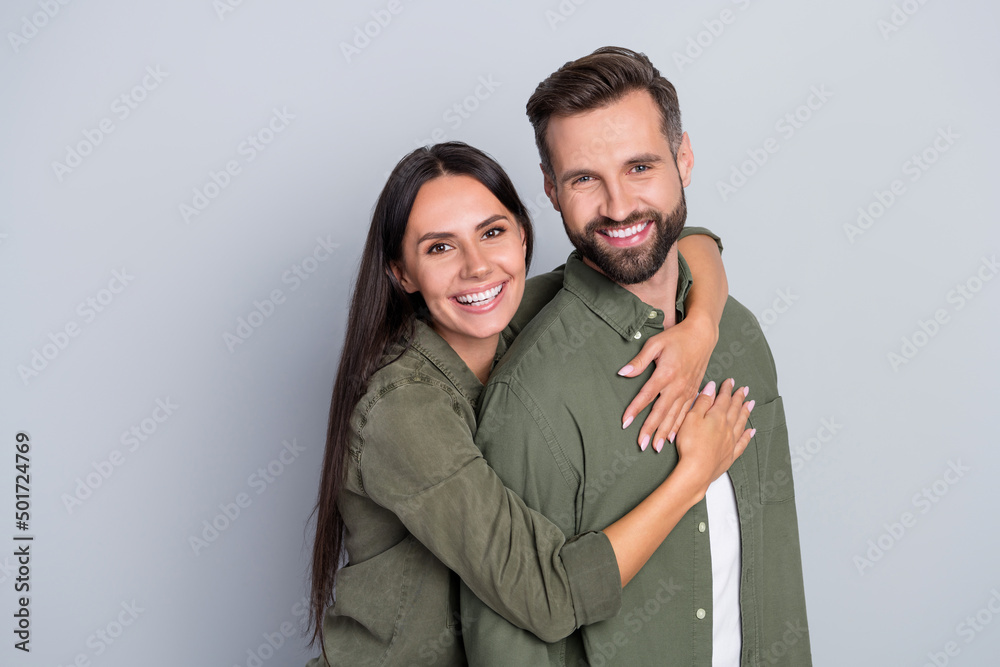 Fototapeta premium Portrait of attractive cheerful amorous couple best friends hugging romance spending time isolated over grey pastel color background