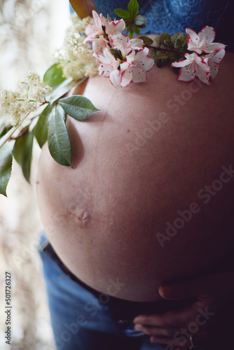 pregnant woman belly with flowers