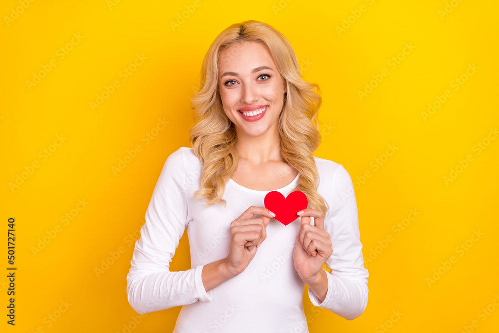 Photo of funny pretty lady dressed white shirt rising small heart isolated yellow color background Photo of funny pretty lady dressed white shirt rising small heart isolated yellow color background