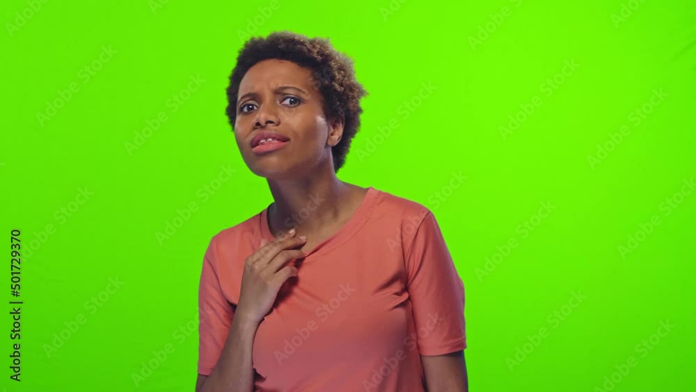 Young cheerful ethnic African American woman starts to genuinely laugh after hears joke or anecdote from friend wearing casual pink t-shirt stands on green background. People, positive emotions Young cheerful ethnic African American woman starts to genuinely laugh after hears joke or anecdote from friend wearing casual pink t-shirt stands on green background. People, positive emotions