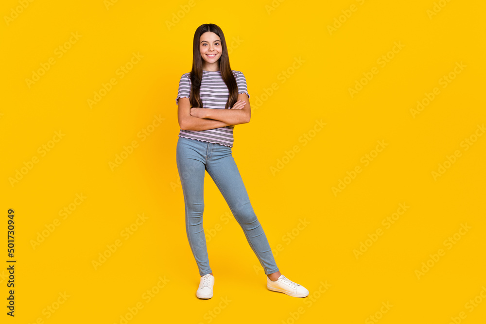 Full length body size view of attractive slim cheerful girl folded arms copy space isolated over bright blue color background Full length body size view of attractive slim cheerful girl folded arms copy space isolated over bright blue color background