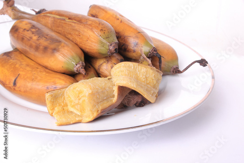 Boiled banana on a white plate, perfect for a snack for breaking the fast for Muslims. Traditional Indonesian snack, from banana kepok or other names banana Nipah or Saba banana. clipping path