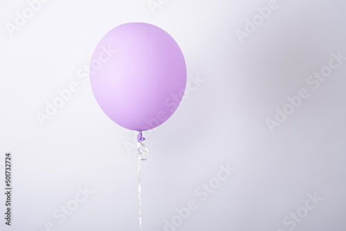 one minimal purple balloon on white background, copy space, element of decorations for birthday party, wedding, festival