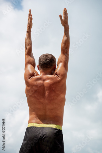 Athletic man warming up and stretching. Outdoor workout