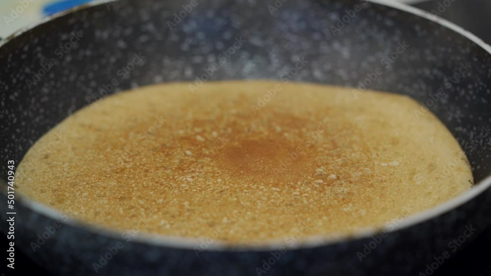 Delicious golden pancake is fried on the pan. High quality 4k footage Delicious golden pancake is fried on the pan. High quality 4k footage