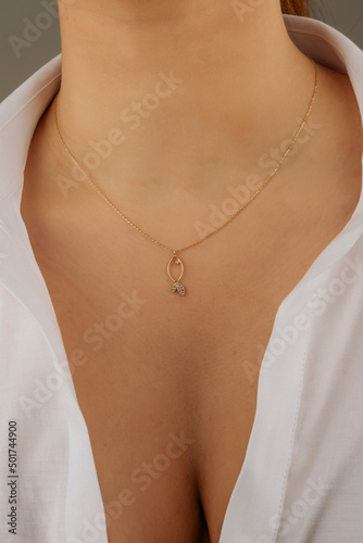 women's gold pendant around the neck of a girl, women's jewelry, pendant with stones, women's accessories, women's jewelry