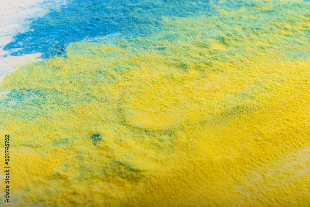 Ukrainian flag colours. The concept of war in Ukraine. Blue and yellow background from holi powder paint.