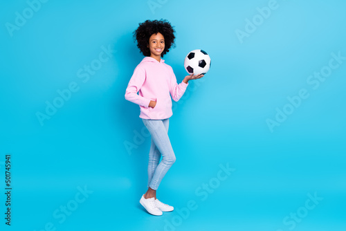 Full length body size view of beautiful trendy sporty cheerful girl holding ball active rest isolated over bright blue color background