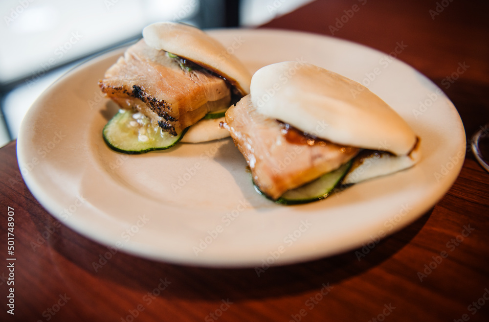 Steamed yeast dough rolls with pork belly, hoisin sauce and cucumber. Steamed yeast dough rolls with pork belly, hoisin sauce and cucumber.