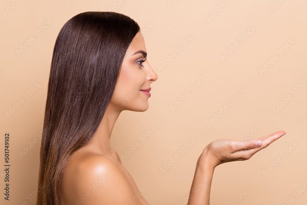 Profile side view portrait of attractive girl holding on palms copy space anti loss isolated over beige pastel color background - obrazy, fototapety, plakaty 