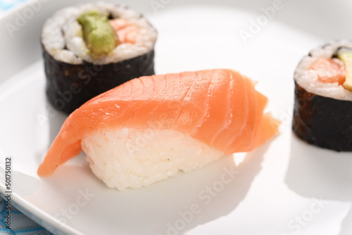 Sushi and rolls on a white plate.