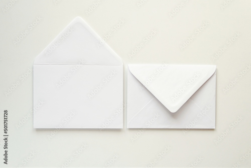 Two white blank envelopes front and back, mockup for design or address label presentation, minimal composition. Two white blank envelopes front and back, mockup for design or address label presentation, minimal composition.