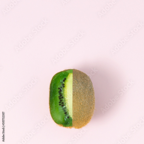 Kiwi fruit on pastel pink background. Minimal flat lay concept.