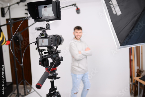 young man video camera operator making interview in professionnal broadcast tv movie studio film production