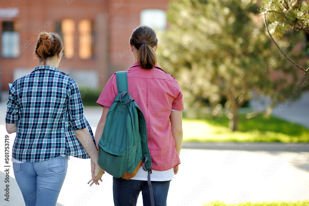 Young couple of students with books and notes outdoors. Smart guy and girl in University campus. Learning and education for young people. Young couple of students with books and notes outdoors. Smart guy and girl in University campus. Learning and education for young people.