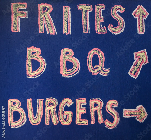 Hand written sign advertising french fries, BBQ and burgers photo