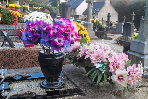 Bouquet of artificial flowers on a tombstone