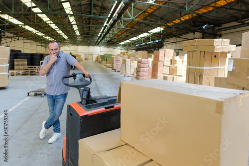 Fototapeta warehouse worker with boxes ready to be deliver