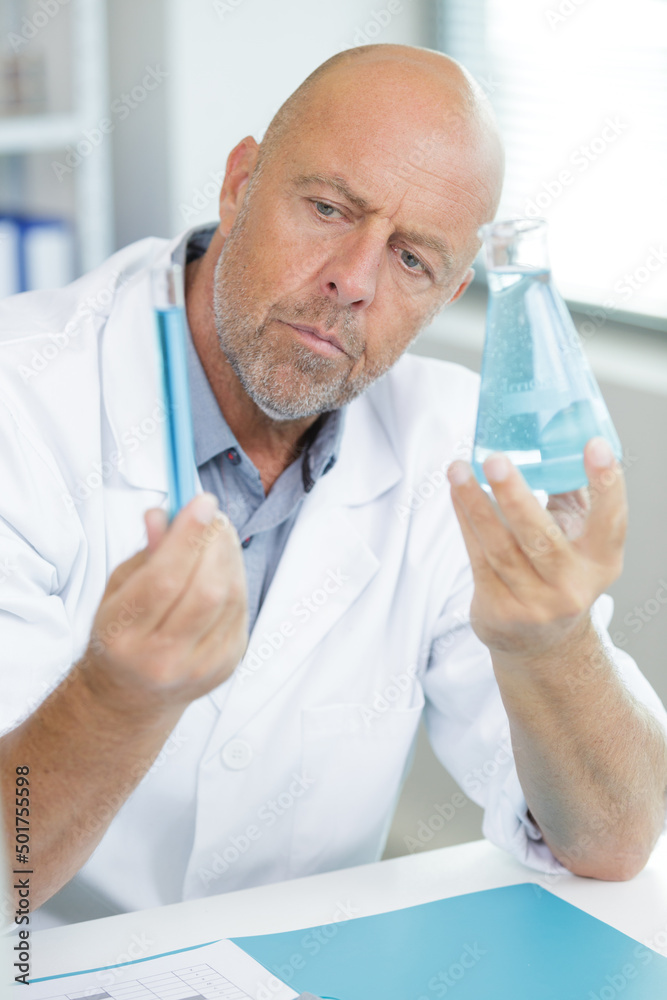 mature gentleman using a pipette mature gentleman using a pipette