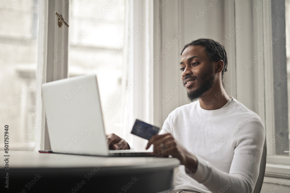 Fototapeta premium young man does online shopping