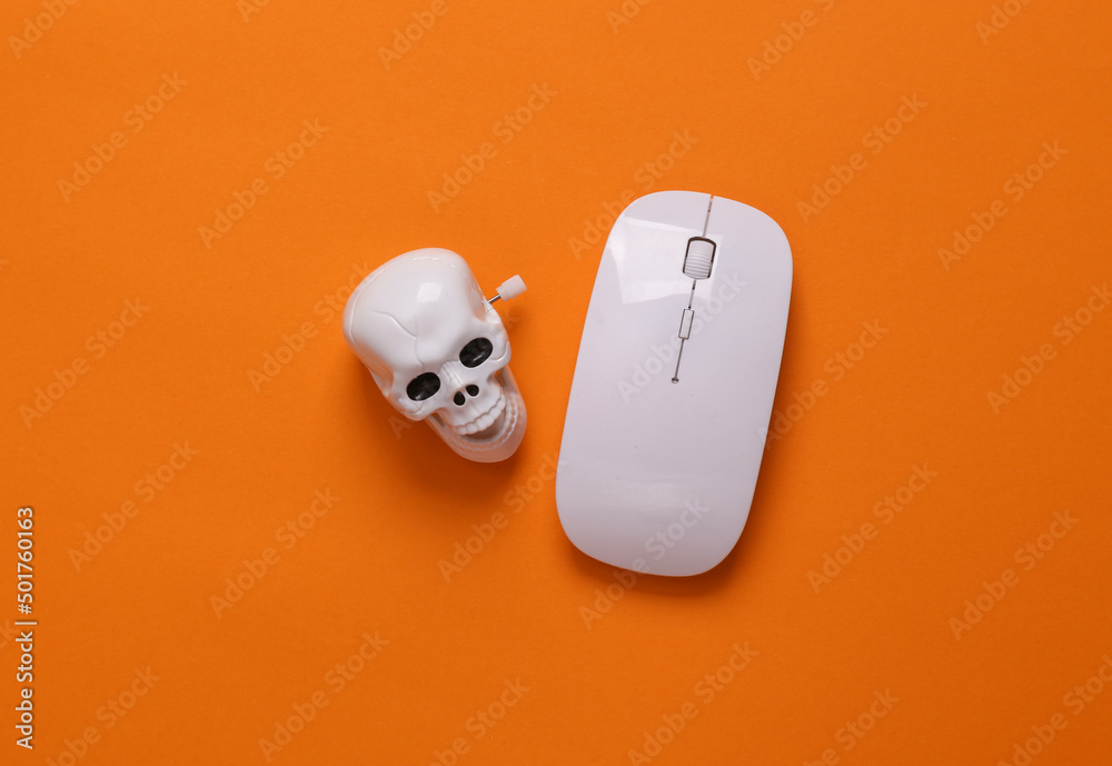 Skeleton skull with pc mouse on orange background. Computer virus, malicious website Skeleton skull with pc mouse on orange background. Computer virus, malicious website