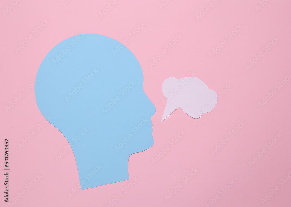 Paper cut human head with blank dialog cloud on pink background