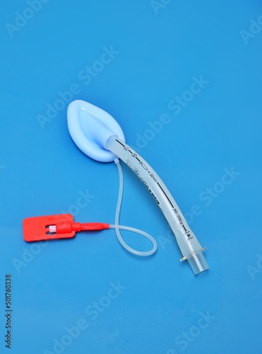 An adult laryngeal mask airway (LMA). Image isolated on blue background.
