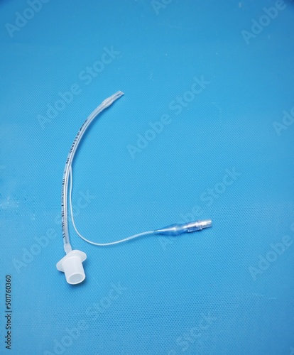 A pediatric endotracheal tube isolated on blue background photo