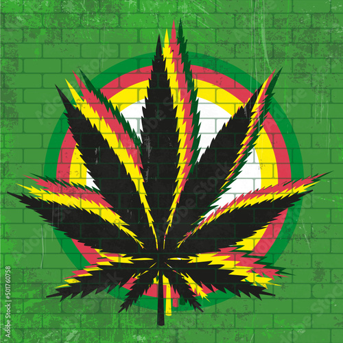 Weed leaf paintind in a wall with rasta colors and brick texture