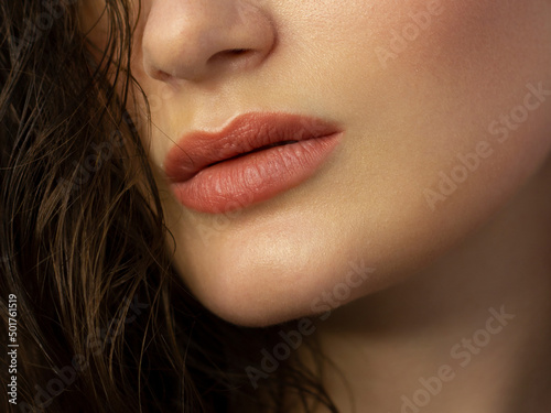 Close-up of woman s Lips with Fashion pink Make-up and Manicure on Nails. Beautiful female full lips with perfect Makeup. Part of female face. Macro shot of beautiful make up on full lips