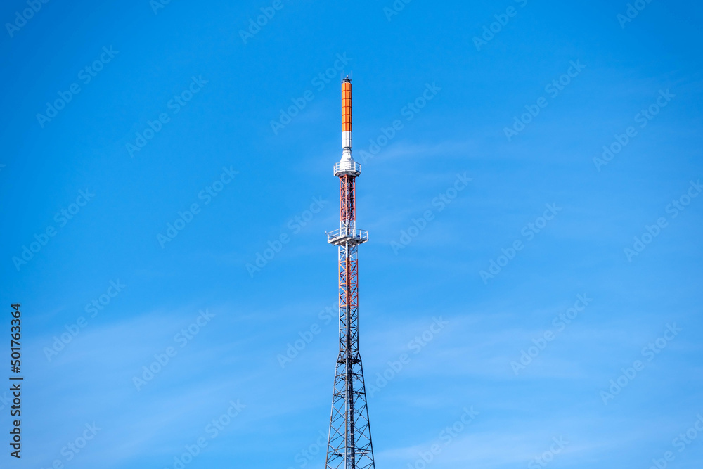 telecommunication tower with antennas on a blue sky
